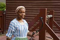 Interpreter Imani Turner draws fresh water from the well. 