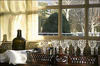 A bottle of wine and fine crystal goblets sit ready for a party in the Palace.