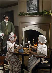 Girls play with dolls at the Powell House