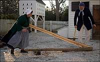 Thon and Carr splitting the carefully selected log of white oak, the preferred wood in Virginia basketmaking.