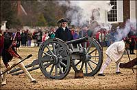 Cannon let fly as Colonial Williamsburg's Thomas Jefferson, Bill Barker, looks across Market Square.