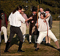 Pick-up sticks for big boys. Colonial Williamsburg interpreters Brian Simpers, left and Bill Rose at play, wielding ash clubs to brain each other in a bout of cudgeling. Behind them, Willie Wright, Joe Garcia, Frank Megargee and Jeff Geyer.