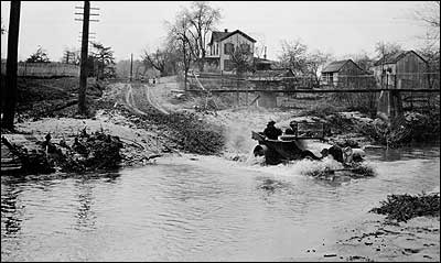 Car crossing stream, 1920s