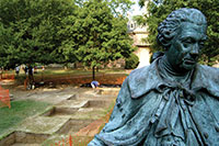 A replica statue of Lord Botetourt, one of Virginia’s last royal governors, stands in front of planting beds excavated in the College of William and Mary’s Wren yard