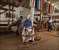 Turning fibers into cloth, weavers Sandy Gibb, Eileen Hammond, and Max Hamrick Jr. keep alive the eighteenth-century practices of the trade.