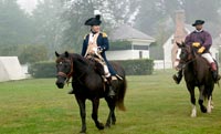 On horseback, Schneider as Lafayette rides with Rex Ellis, as his aide.